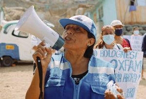 Janet Fuentes leads a march in her community of Santa Rosa in Lima, Peru