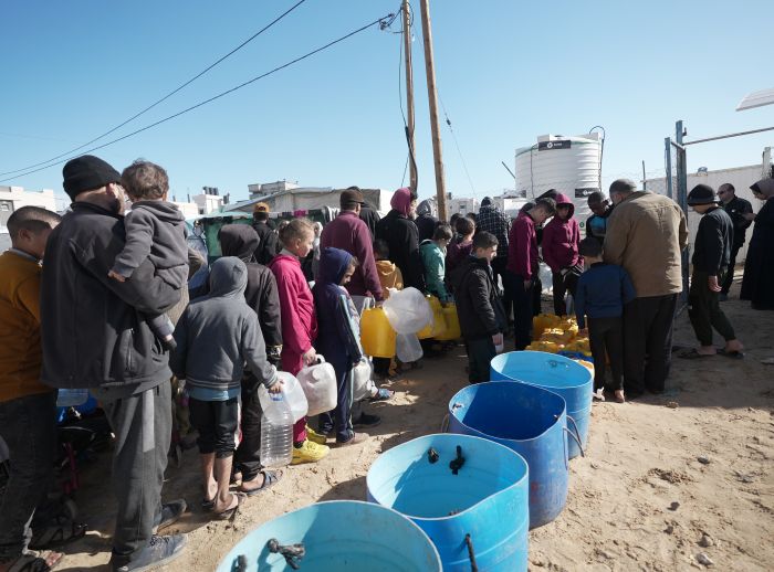 Families queuing up to use one of Oxfam’s five desalination units.