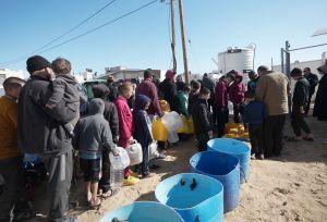 Families queuing up to use one of Oxfam’s five desalination units.