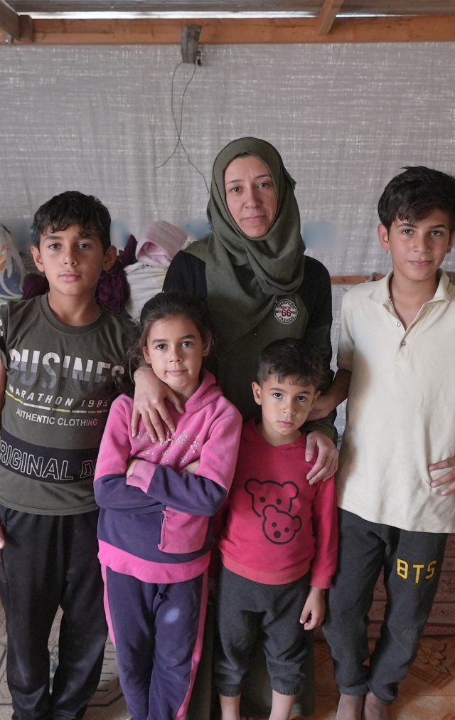 A mother Wesam is standing in the middle of her tent along with her 4 children in Gaza.