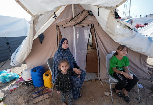 A mother and her children currently residing in the Khan Younis refugee camp, which was established by the United Nations Relief and Works Agency (UNRWA) and is now known as the Khiam (Tents) Camp.