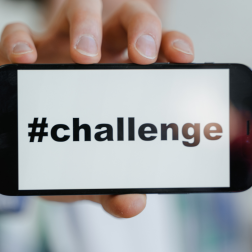 A mobile phone with the word #challenge on the screen