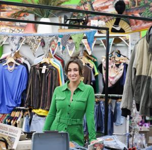 Fiona, store manager standing in the middle of the vintage section of the Oxfam Holywood Superstore.