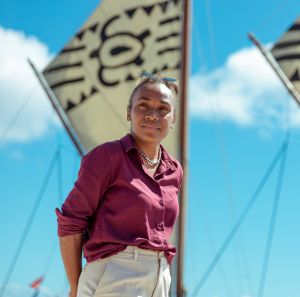 Cynthia Houniuhi stands in front of the Uto ni Yalo boat at the Pacific Island Forum in Tonga.